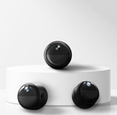Three black cylindrical mini magnetic wifi cameras on a white platform with a light gray background