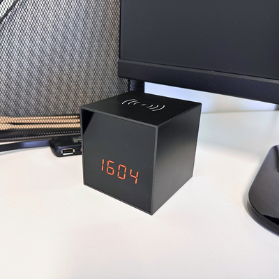 The Awaretech Clock Hidden Camera in an office space (on a desk), showing that the cameras are not visible.