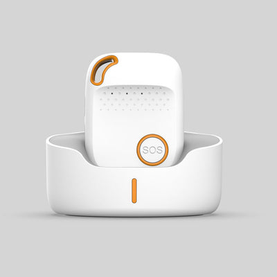 White and orange personal alarm device with an SOS button, shown standing in a matching charging dock.