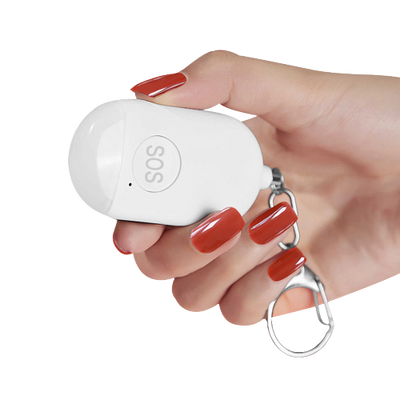 Small white oval shaped device featuring a keychain and SOS emergency button held in a woman's hand. - The Spy Store