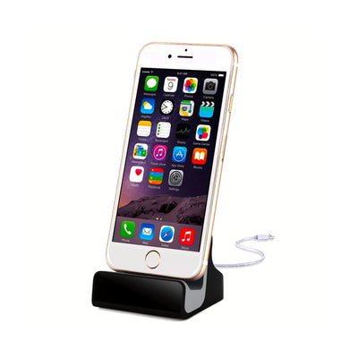 A white iPhone 6 connected and charging on the dock.